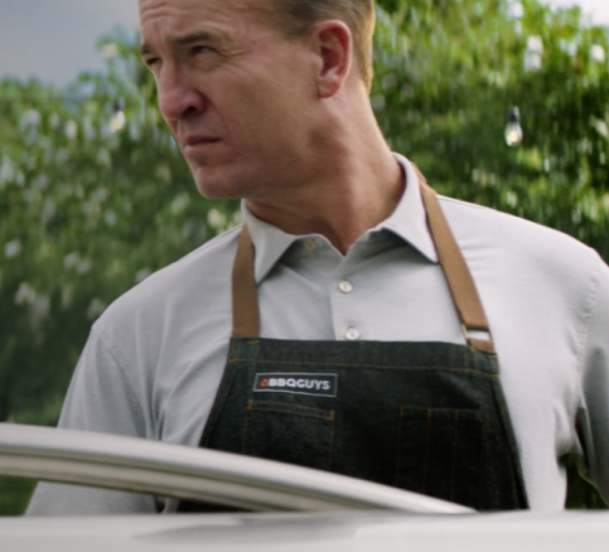 Peyton Manning overlooking a grill.