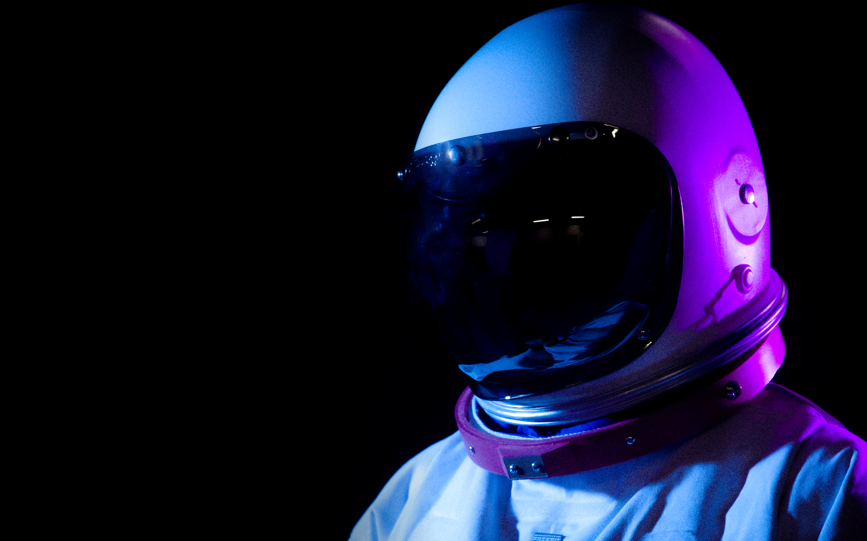 An astronaut in blue and purple light.