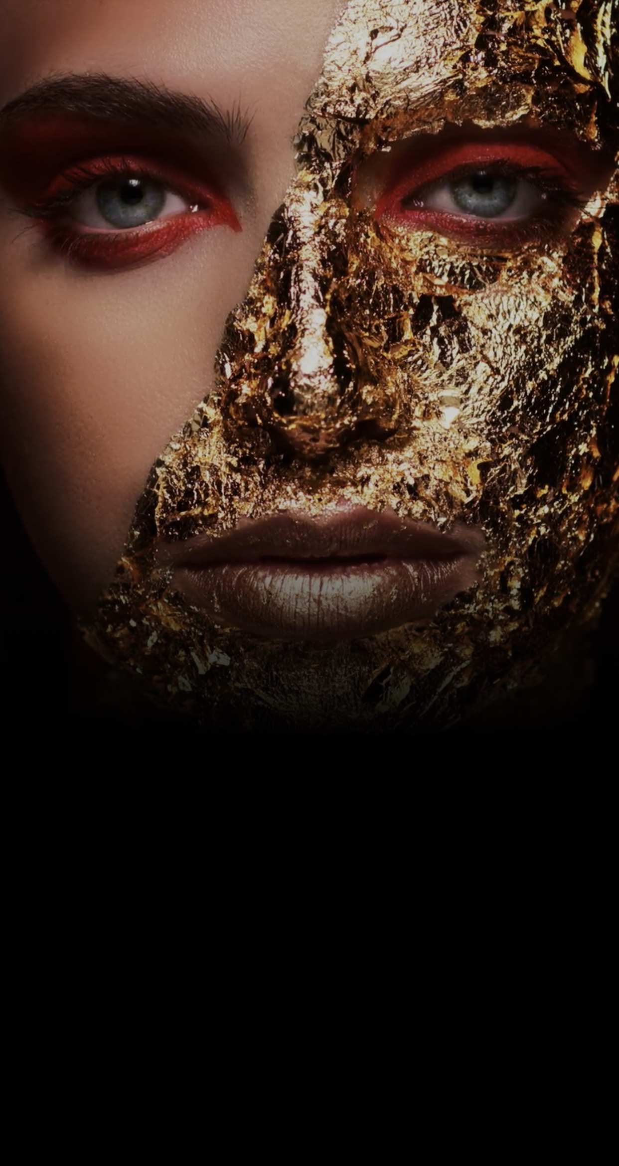 A woman with golden foil covering half her face.