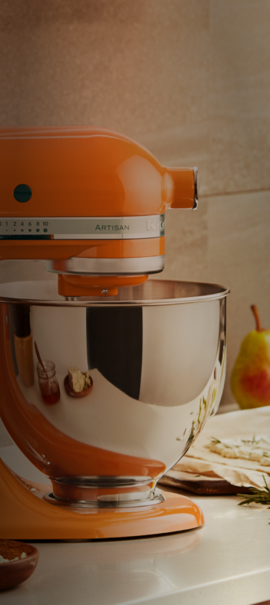 A KitchenAid stand mixer in orange.