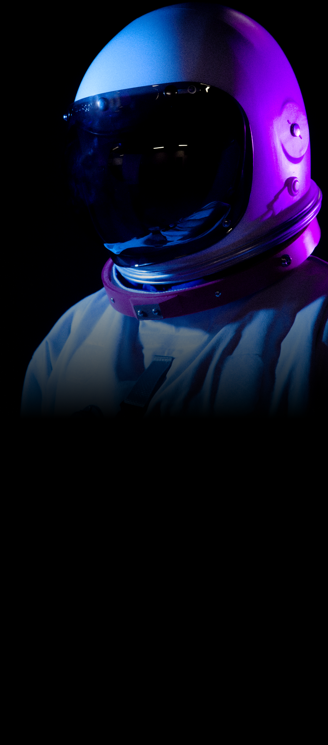 An astronaut's helmet on a black background.