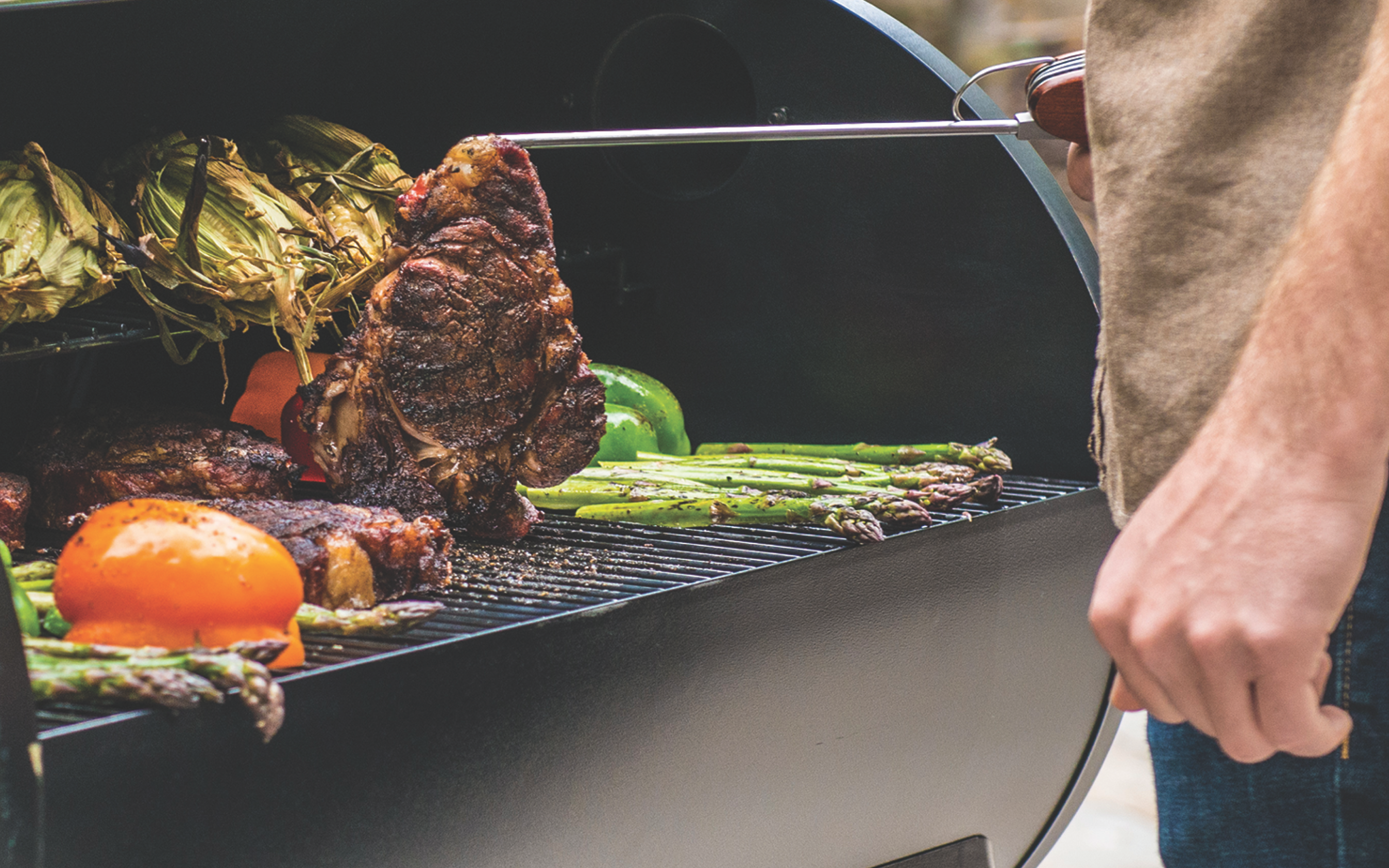 Steaks and vegetables on a grill.