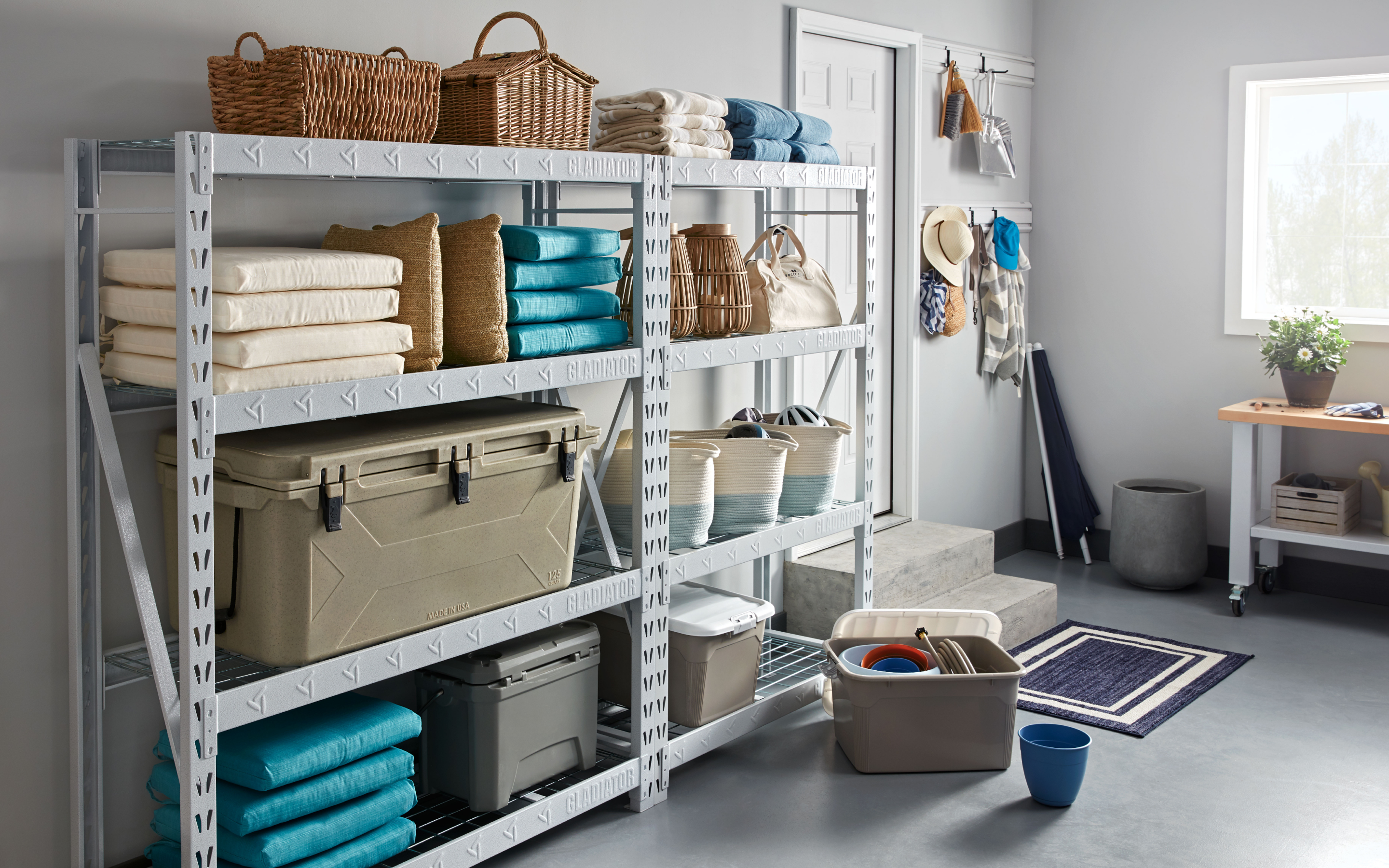 Various storage devices, pillows and outdoor chair cushions stored on a Gladiator brand rack system.